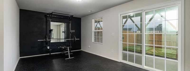 Wide view of an empty modern minimalist home gym space